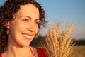 Young woman face with earns on wheaten field Royalty Free Stock Photo