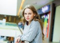 Young woman with face with freckles is standing in supermarket.