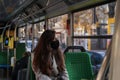 Young woman is face mask is travelling by bus. Precautions in public transport