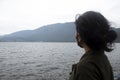 Young woman with face masker in the lake, looking at the view.