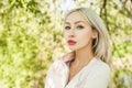 Young woman face outdoors on green leaves Royalty Free Stock Photo