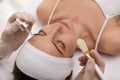 Young woman during face peeling procedure