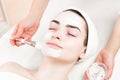 Young woman facial mask applying in beauty parlour Royalty Free Stock Photo
