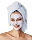 Young woman with facial mask on her face. Skin care and treatment, spa, natural beauty and cosmetology concept, isolated over Royalty Free Stock Photo