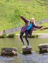 Young woman falling from stepping stones Royalty Free Stock Photo