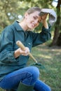young woman farmer cleans rake dry grass Royalty Free Stock Photo