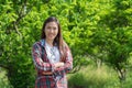 Young woman farmer smiling and standing in blurred custard apple trees orchard background Royalty Free Stock Photo