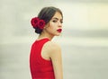 Young woman in fashionable, red dress walking. Beautiful teen, beauty and fashion, teenager love and romance. Dreams