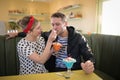 Woman feeding ice cream to man in restaurant Royalty Free Stock Photo