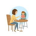 Young woman feeding with a spoon her little child sitting in a baby chair Royalty Free Stock Photo