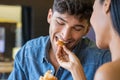 Young woman feeds his boyfriend