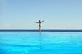 Young woman feel freedom and enjoying relaxationin infinity pool , travel and leisure, vacation retreat in Bali. Royalty Free Stock Photo