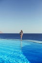 Young woman feel freedom and enjoying relaxationin infinity pool , travel and leisure, vacation retreat in Bali. Royalty Free Stock Photo