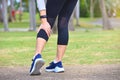 Young woman feel pain on her leg while exercising