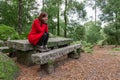 Young woman feeling depressed sitting on a forest