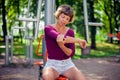 Young woman feeling pain in her elbow, hand during sport workout