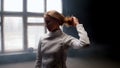 A young woman fencer she lets her hair down from the bun