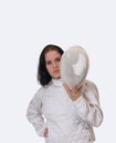 Young woman in fencing jacket with mask