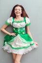 Young woman in a festive dress saint patrick`s day top view looking camera smiling