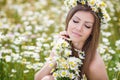 Young woman in a field of blooming daisies Royalty Free Stock Photo