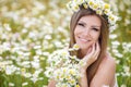 Young woman in a field of blooming daisies Royalty Free Stock Photo