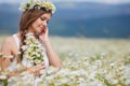 Young woman in a field of blooming daisies Royalty Free Stock Photo