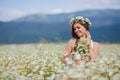 Young woman in a field of blooming daisies Royalty Free Stock Photo