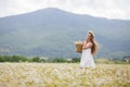 Young woman in a field of blooming daisies Royalty Free Stock Photo