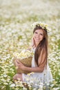 Young woman in a field of blooming daisies Royalty Free Stock Photo