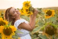 Young woman in a field of sunflowers. sunset light in the field of sunflowers