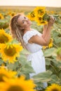 Young woman in a field of sunflowers. sunset light in the field of sunflowers