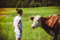 young woman in a field surrounded by cows Royalty Free Stock Photo