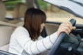 Young woman find something in drawer front of car with carelessness while driving - accident concept. Royalty Free Stock Photo