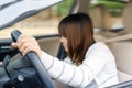 Young woman find something in drawer front of car with carelessness while driving - accident concept.