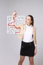 Young woman finding the maze solution, writing on whiteboard. Royalty Free Stock Photo