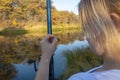 Young woman fisherman holds fishing rod hook with live bait. Fishing with a worm