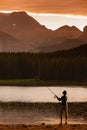 Young Woman fishing at Margaret Lake in the Waiparous area Alberta Canada Royalty Free Stock Photo