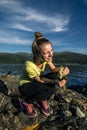 Young woman is fishing in Norway