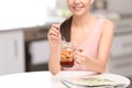 Young woman in fitness clothes having breakfast at home, closeup