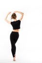 Young woman fitness. Full length from the back in black sportswear on a white background Royalty Free Stock Photo