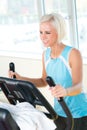 Young woman on fitness machine cardio exercise Royalty Free Stock Photo