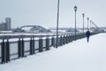 Young woman fitness model running at snow winter park, pink sneakers - wide angle Royalty Free Stock Photo