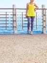 Young woman in fitness outfit looking aside at embankment Royalty Free Stock Photo