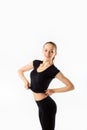 Young woman fitness. Smiles and raises black sports jersey Royalty Free Stock Photo