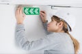 Young woman fittoing exit sign Royalty Free Stock Photo