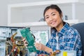 Young woman fixing computer