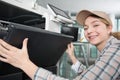 Young woman fixing printer Royalty Free Stock Photo