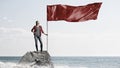 Young woman with flag . Mixed media Royalty Free Stock Photo