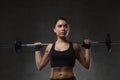 Young woman flexing muscles with barbell in gym Royalty Free Stock Photo