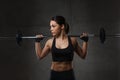 Young woman flexing muscles with barbell in gym Royalty Free Stock Photo